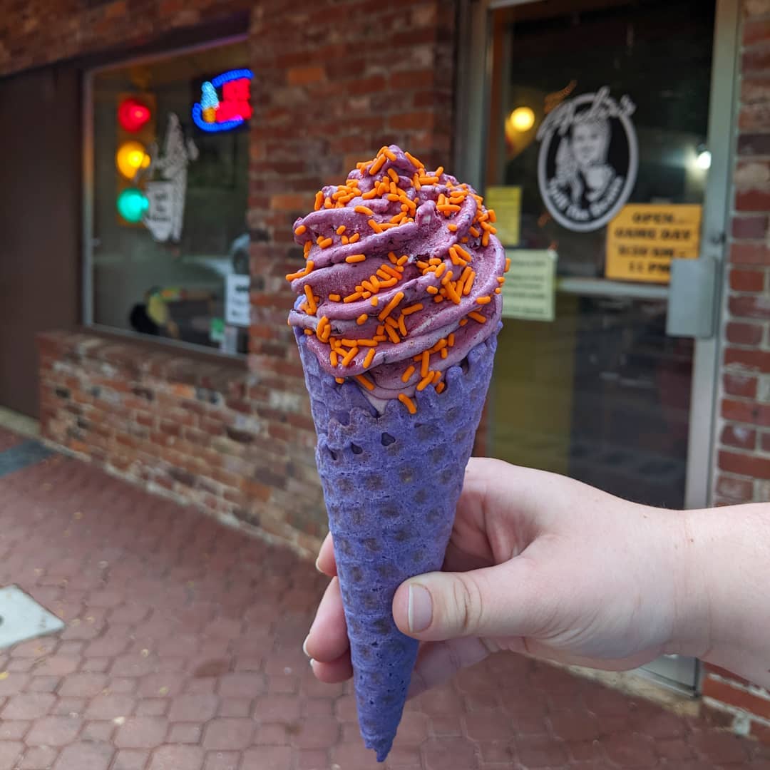 Purple waffle cone with purple ice cream and orange sprinkles (clemson themed)